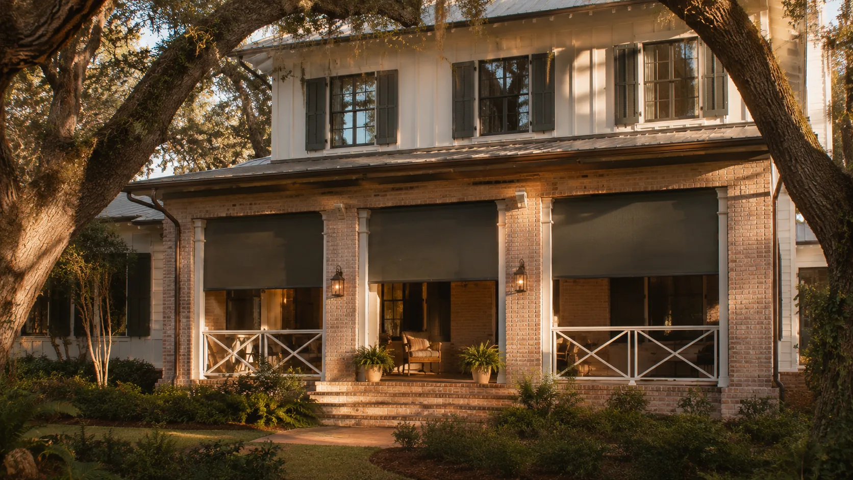 Two-story Southern home elevation at late afternoon with three covered openings each fitted with deep sun-blocking exterior roller shades